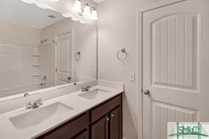 full bathroom featuring double vanity, a sink, and a notable chandelier