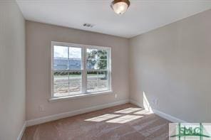spare room with carpet floors and baseboards