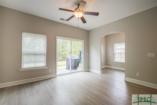 270 Kepler Loop, Richmond Hill, GA 31324 - empty room with arched walkways, wood finished floors, a ceiling fan, and baseboards