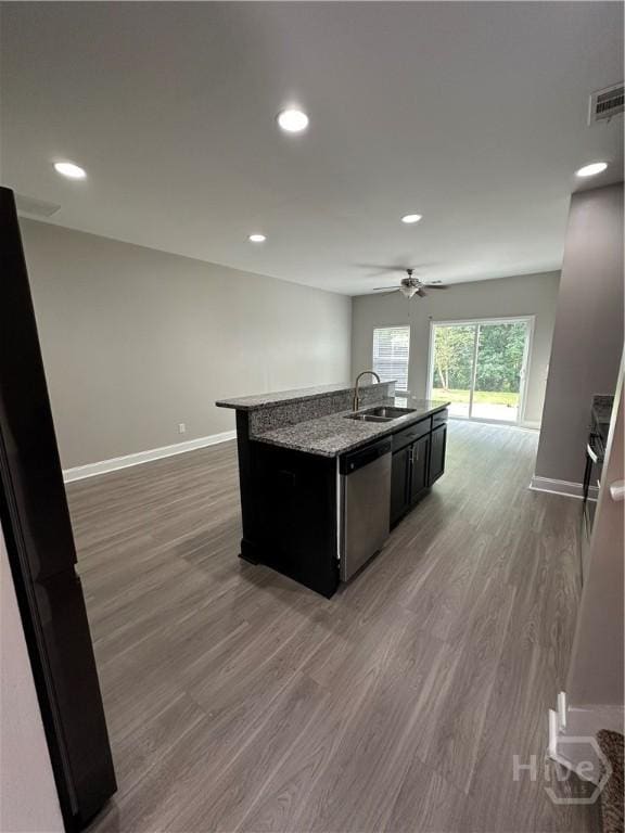 270 Kepler Loop, Richmond Hill, GA 31324 - kitchen with stainless steel dishwasher, wood finished floors, an island with sink, baseboards, and open floor plan