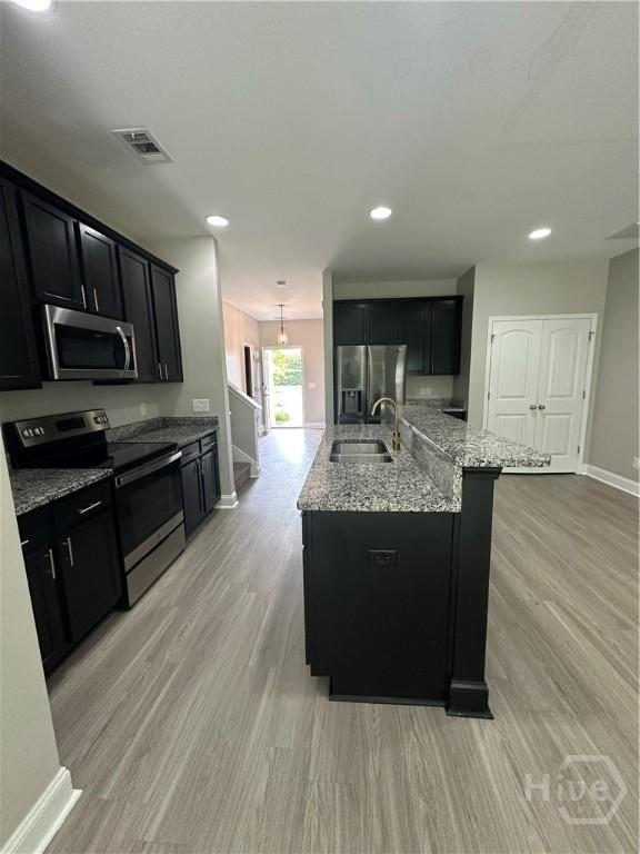 270 Kepler Loop, Richmond Hill, GA 31324 - kitchen with appliances with stainless steel finishes, dark cabinets, baseboards, a sink, and recessed lighting