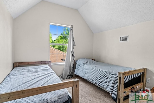 carpeted bedroom featuring a textured ceiling, visible vents, and vaulted ceiling