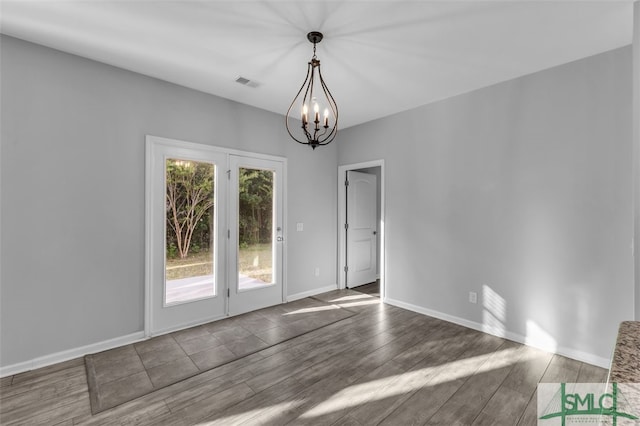 95 Wando View Way, Richmond Hill, GA 31324 - unfurnished dining area with visible vents, baseboards, wood finished floors, and a chandelier