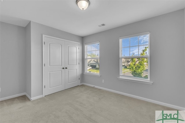 95 Wando View Way, Richmond Hill, GA 31324 - unfurnished bedroom featuring visible vents, baseboards, a closet, and light carpet
