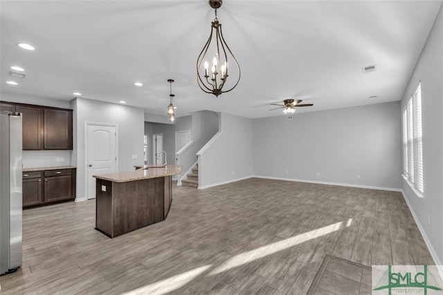95 Wando View Way, Richmond Hill, GA 31324 - kitchen featuring visible vents, freestanding refrigerator, dark brown cabinets, a sink, and light wood finished floors