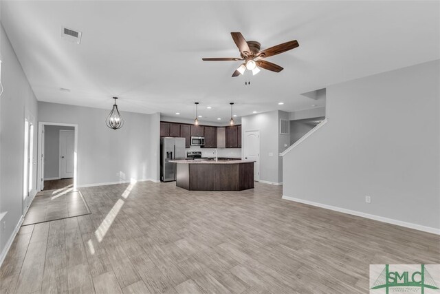 95 Wando View Way, Richmond Hill, GA 31324 - unfurnished living room featuring visible vents, baseboards, light wood-style floors, recessed lighting, and ceiling fan with notable chandelier