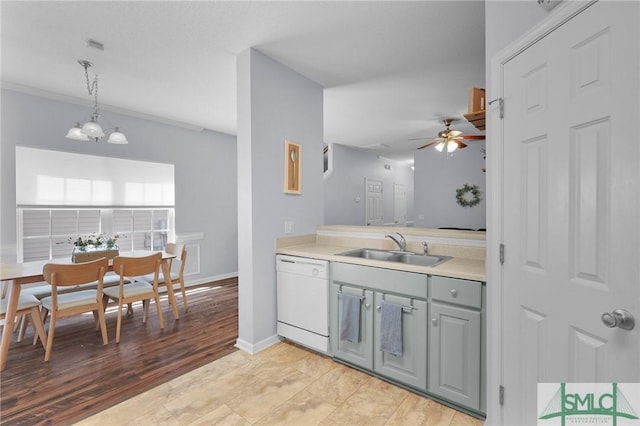 777 King George Blvd Unit 57, Savannah, GA 31419 - kitchen with white dishwasher, a sink, light countertops, ceiling fan, and decorative light fixtures