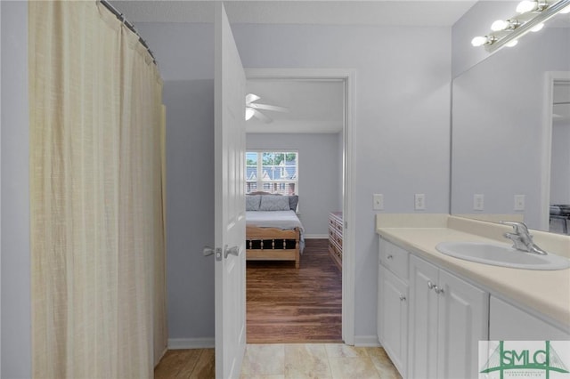 777 King George Blvd Unit 57, Savannah, GA 31419 - bathroom featuring connected bathroom, vanity, a ceiling fan, and baseboards