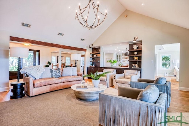 16 Modena Island Dr, Savannah, GA 31411 - living area with high vaulted ceiling, plenty of natural light, light wood-style floors, a chandelier, and baseboards