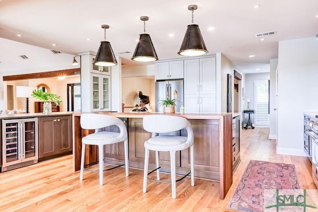 16 Modena Island Dr, Savannah, GA 31411 - kitchen featuring wine cooler, high end fridge, light wood-style floors, light countertops, and recessed lighting