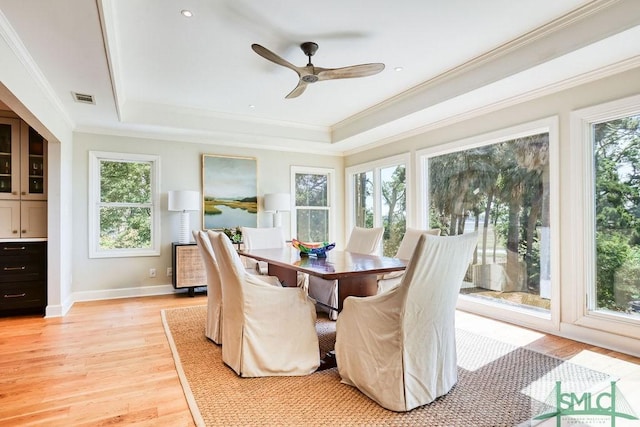 16 Modena Island Dr, Savannah, GA 31411 - dining space featuring a tray ceiling, light wood-type flooring, ceiling fan, crown molding, and baseboards