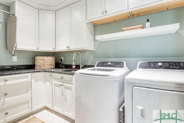 laundry area featuring independent washer and dryer, cabinet space, and a sink