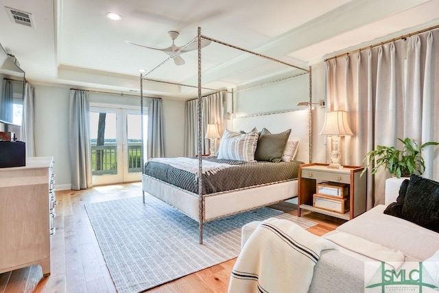 16 Modena Island Dr, Savannah, GA 31411 - bedroom with a tray ceiling, access to exterior, light wood-style flooring, recessed lighting, and baseboards