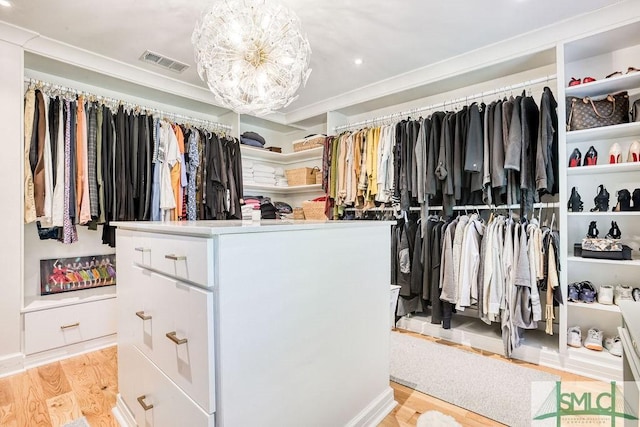 16 Modena Island Dr, Savannah, GA 31411 - spacious closet featuring light wood-style flooring and a chandelier