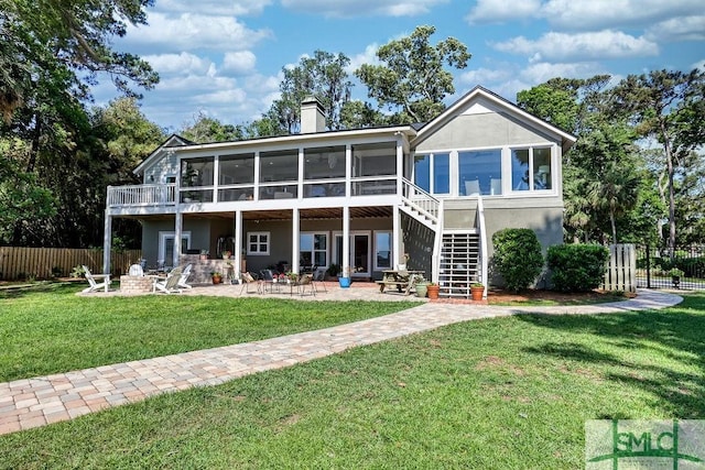 16 Modena Island Dr, Savannah, GA 31411 - back of property with a sunroom, stucco siding, a chimney, a patio, and stairs