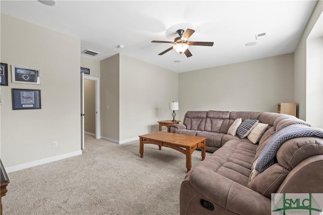 living area featuring ceiling fan, visible vents, light carpet, and baseboards