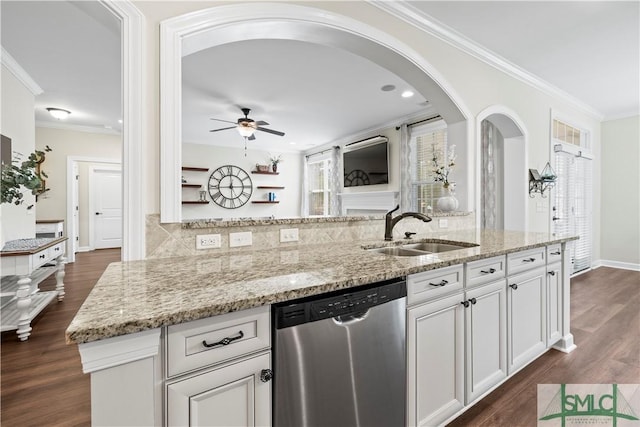 kitchen with a sink, light stone counters, dark wood finished floors, and dishwasher