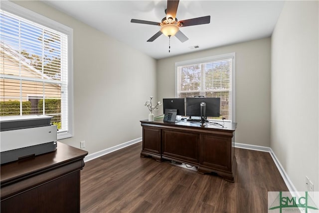office space featuring dark wood-type flooring, baseboards, ceiling fan, and visible vents
