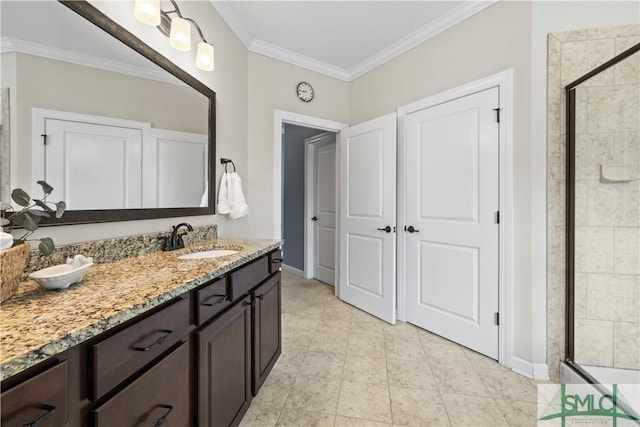full bathroom featuring crown molding, baseboards, vanity, and a stall shower