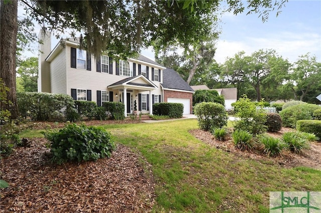 view of front of property featuring an attached garage, a front yard, and a chimney