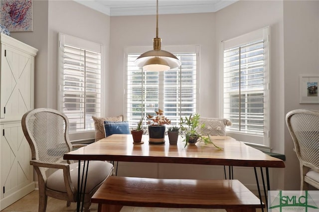 dining space featuring crown molding