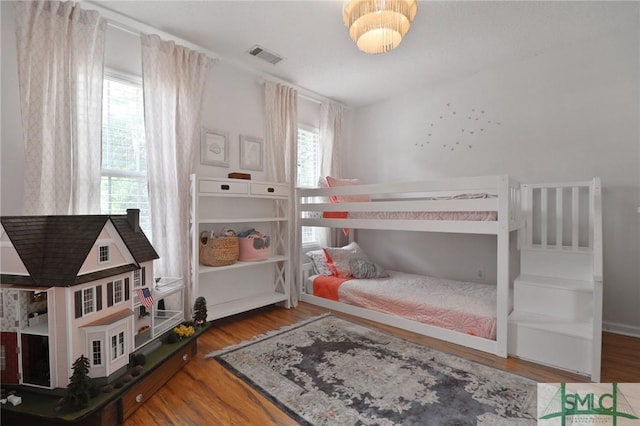 bedroom featuring visible vents and wood finished floors