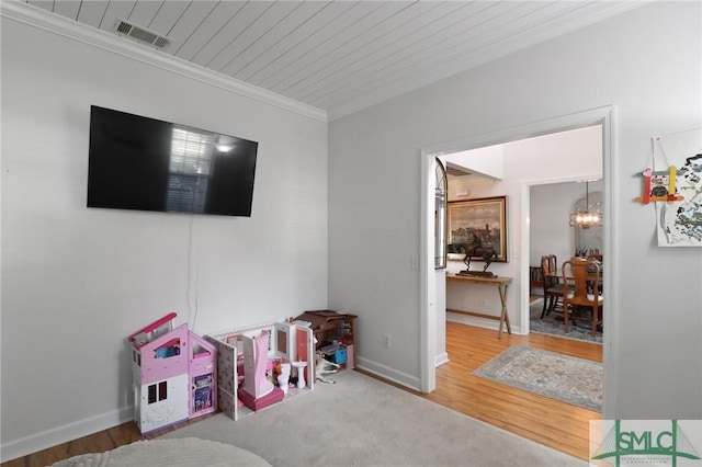 recreation room with wood ceiling, visible vents, wood finished floors, a chandelier, and ornamental molding
