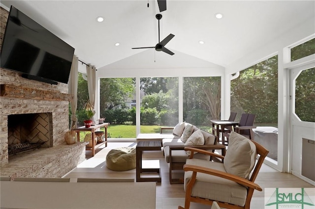 sunroom / solarium featuring recessed lighting, high vaulted ceiling, and wood finished floors
