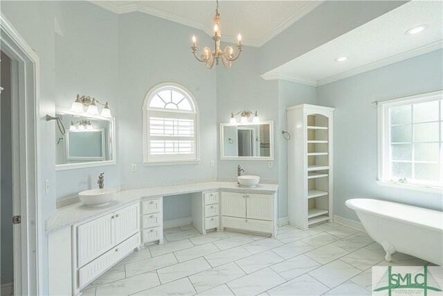 bathroom with crown molding, vanity, marble finish floor, a chandelier, and a soaking tub