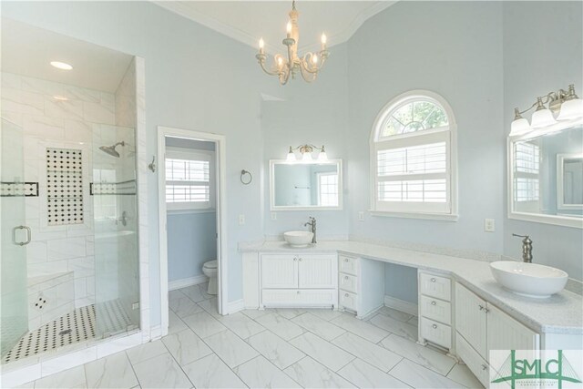 bathroom featuring toilet, a shower stall, a healthy amount of sunlight, and marble finish floor