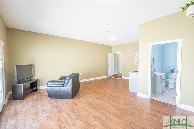 unfurnished room with baseboards and light wood-style flooring