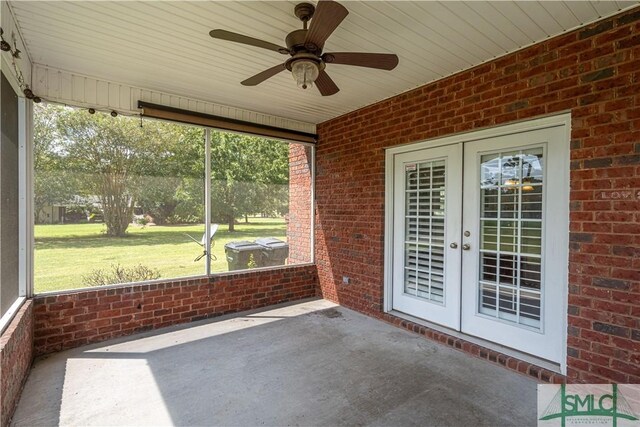 unfurnished sunroom with french doors and a ceiling fan