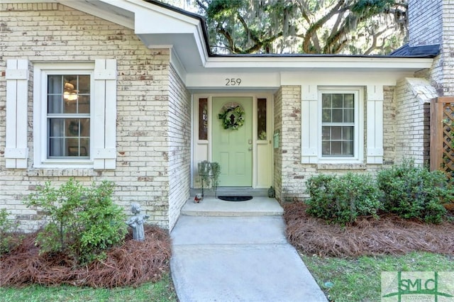 view of exterior entry with brick siding