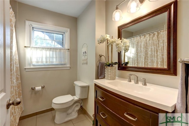 bathroom with toilet, baseboards, tile patterned flooring, and vanity