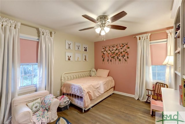 bedroom with baseboards, a ceiling fan, and wood finished floors