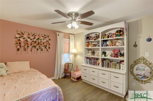 bedroom with baseboards, ceiling fan, and wood finished floors