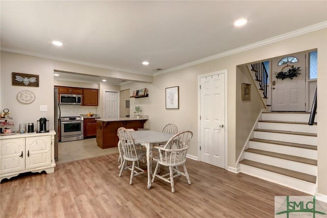 dining space featuring recessed lighting, light wood-style floors, and stairway