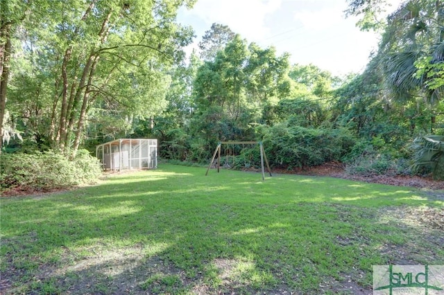 view of yard with an exterior structure and a playground