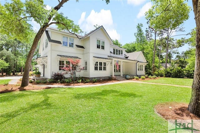 back of property with a lawn