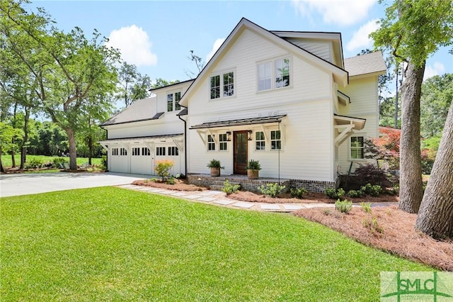 modern farmhouse style home with a garage, driveway, and a front yard