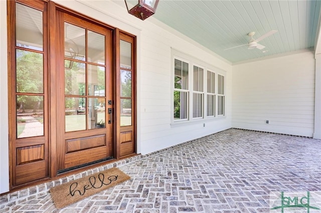 entrance to property featuring french doors and ceiling fan