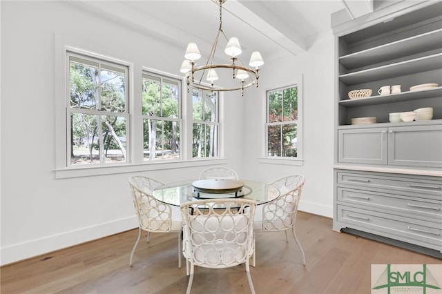 dining area with baseboards, beamed ceiling, light wood finished floors, and a notable chandelier