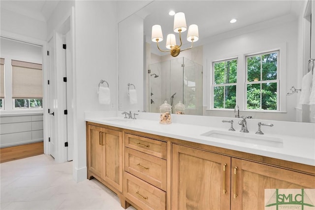 full bathroom with a sink, a stall shower, double vanity, and a chandelier