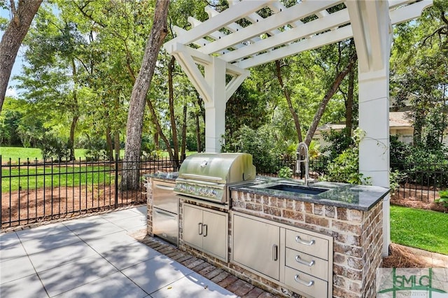 view of patio / terrace with fence, a sink, area for grilling, and a grill