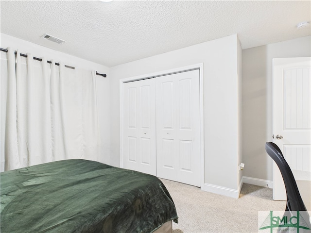 1246 Cypress Fall Cir, Hinesville, GA 31313 - bedroom with visible vents, carpet floors, a closet, baseboards, and a textured ceiling