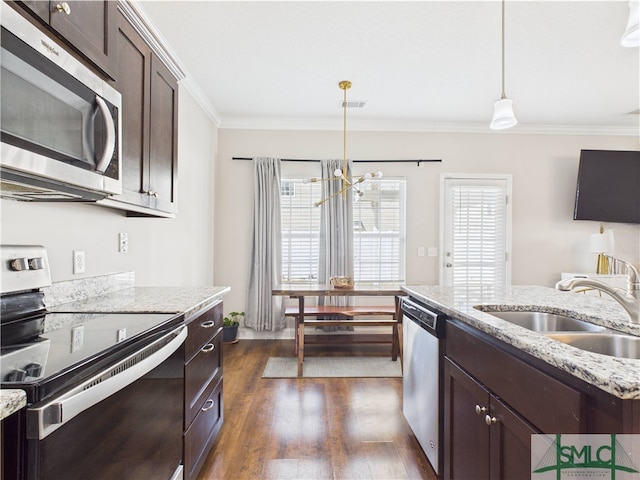 1246 Cypress Fall Cir, Hinesville, GA 31313 - kitchen with dark brown cabinets, a sink, a notable chandelier, ornamental molding, and stainless steel appliances