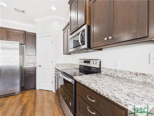 1246 Cypress Fall Cir, Hinesville, GA 31313 - kitchen featuring dark wood-style flooring, dark brown cabinetry, appliances with stainless steel finishes, visible vents, and ornamental molding