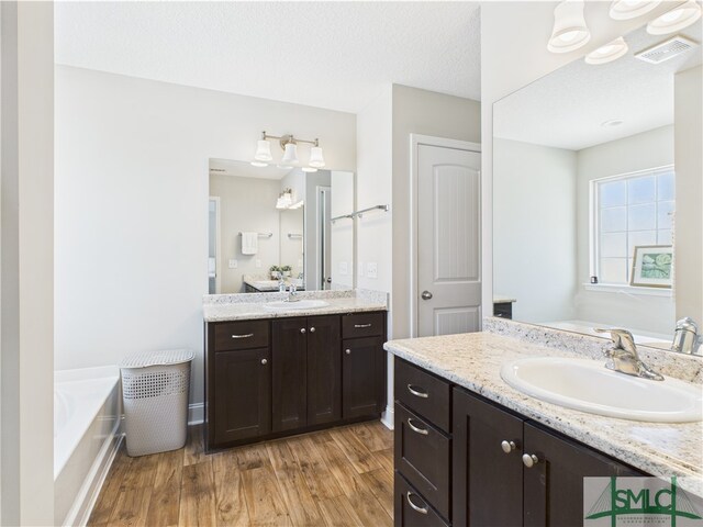 1246 Cypress Fall Cir, Hinesville, GA 31313 - full bathroom featuring a sink, a bath, wood finished floors, and visible vents