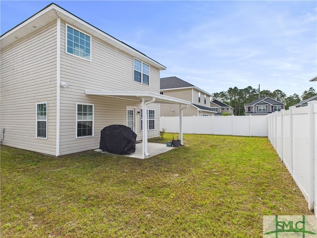 1246 Cypress Fall Cir, Hinesville, GA 31313 - back of property featuring a yard, a patio, and a fenced backyard