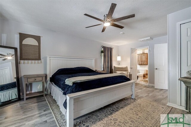 178 Country Way, Springfield, GA 31329 - bedroom with a ceiling fan, a textured ceiling, wood finished floors, and ensuite bath